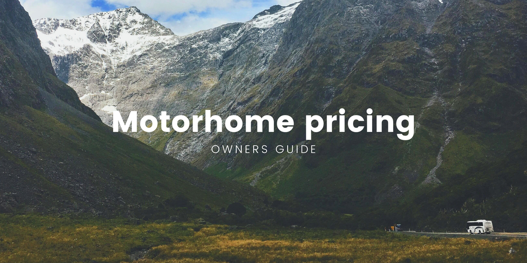 Motorhome parked up at a scenic campsite, mountains in the background.