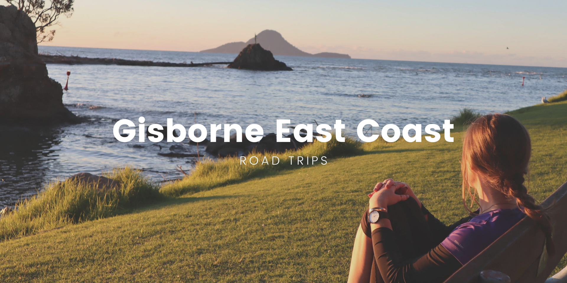 Road trip along the East Coast, with campervan parked overlooking the ocean.