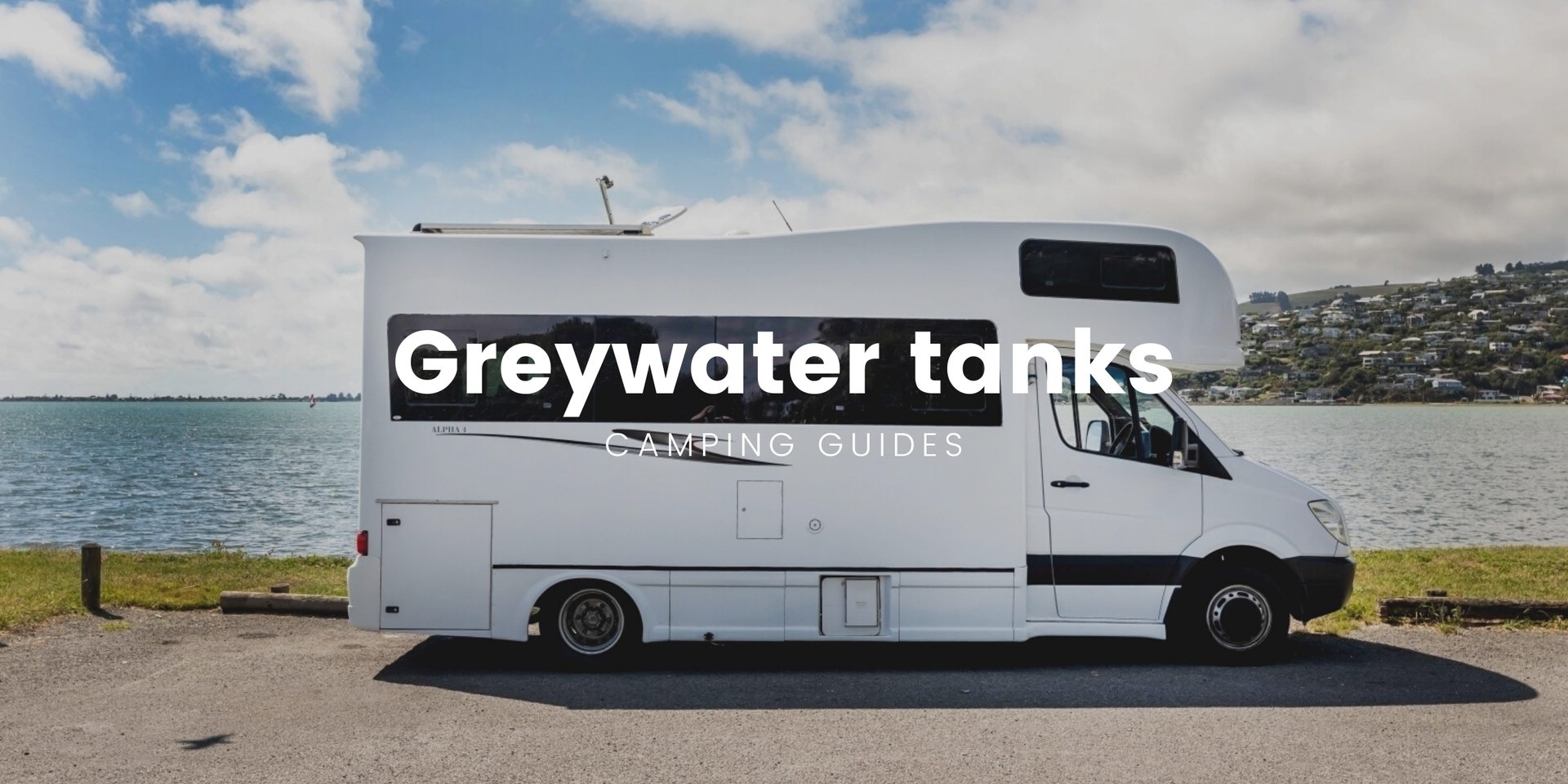 Motorhome at a campsite, ready for grey water tank cleaning. Happy campers!