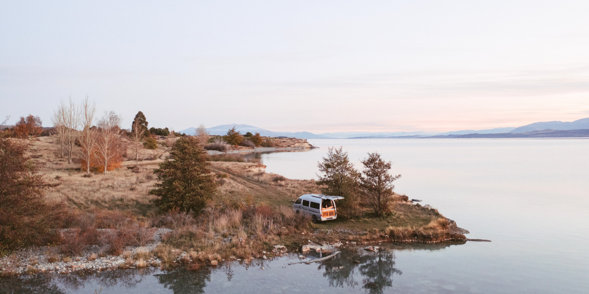 Team Zorali's campervan parked up in front of the Southern Alps, Aotearoa.