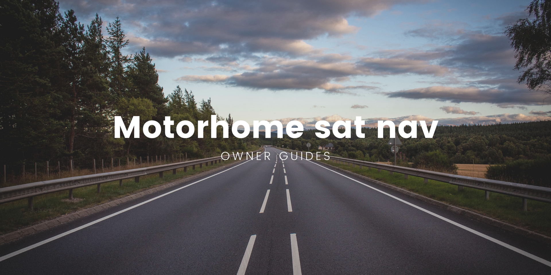 Motorhome parked at scenic viewpoint on a road trip, surrounded by countryside.