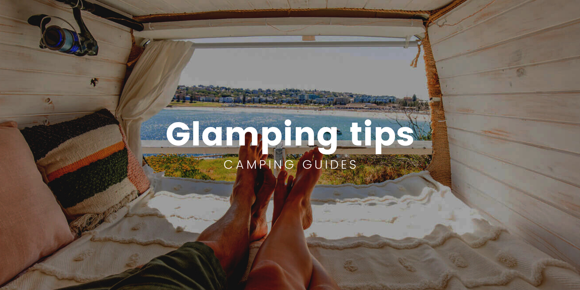 Luxe campsite setup with fairy lights, comfy chairs, and brekkie cooking on the barbie.