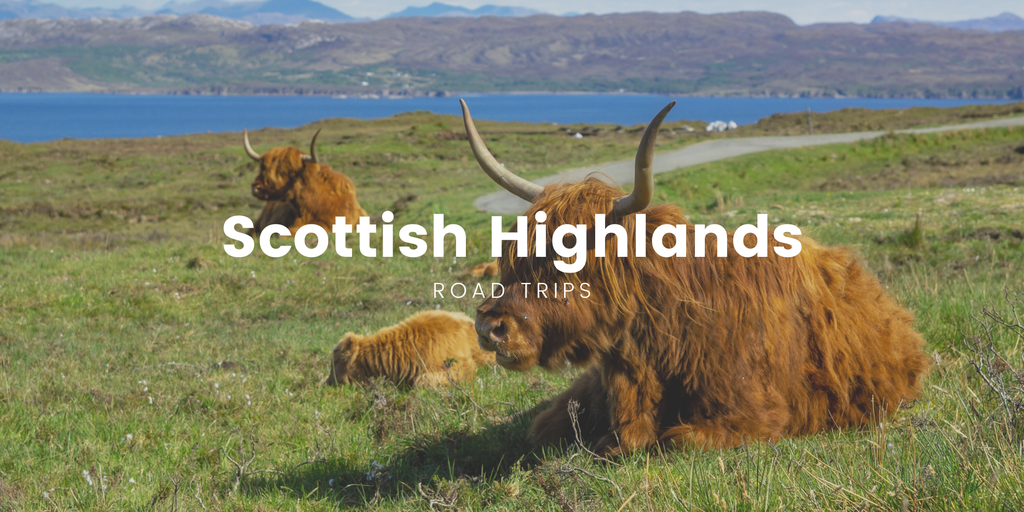 Scenic Highlands road winds past loch, under dramatic skies. Perfect for an unforgettable driving holiday in Scotland.