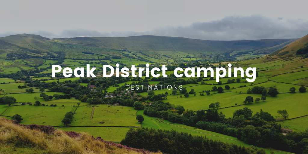 Family pitches a tent in a green Peak District campsite, with rolling hills in the background.