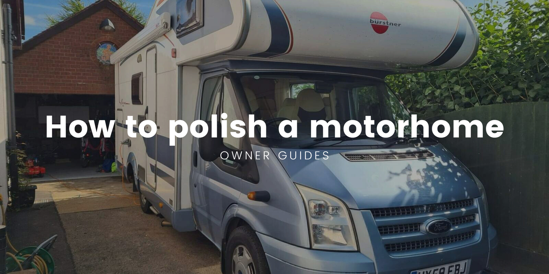 Polished motorhome gleaming in the sun at a scenic campsite. Holiday travel and vehicle care.