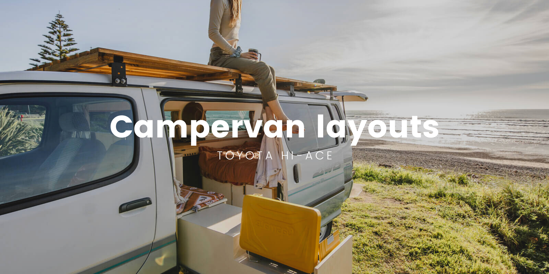 Hiace camper parked at a stunning lakeside campsite, ready for adventure.