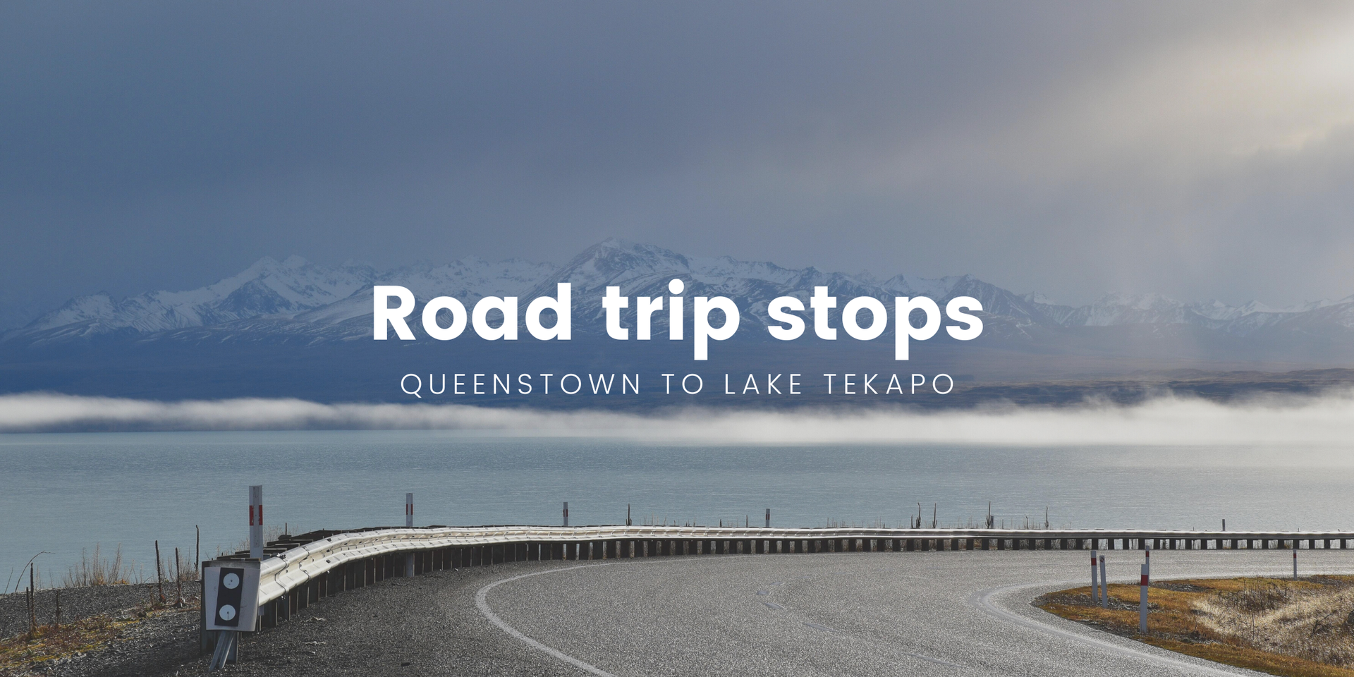 Scenic road trip: Campervan overlooking Lake Pukaki with the Southern Alps in the background.
