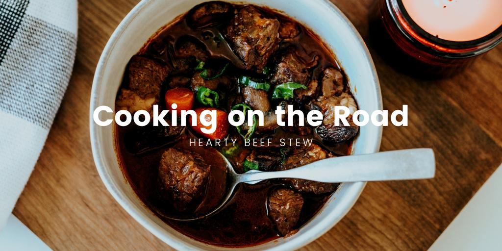 Campfire cook-up: Beef stew simmering in a Dutch oven, surrounded by gum trees.
