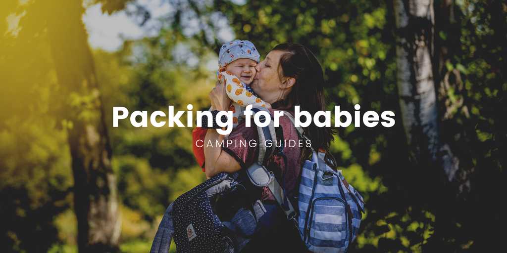 Family tent pitched by a scenic New Zealand lake, ready for a camping holiday with bub.