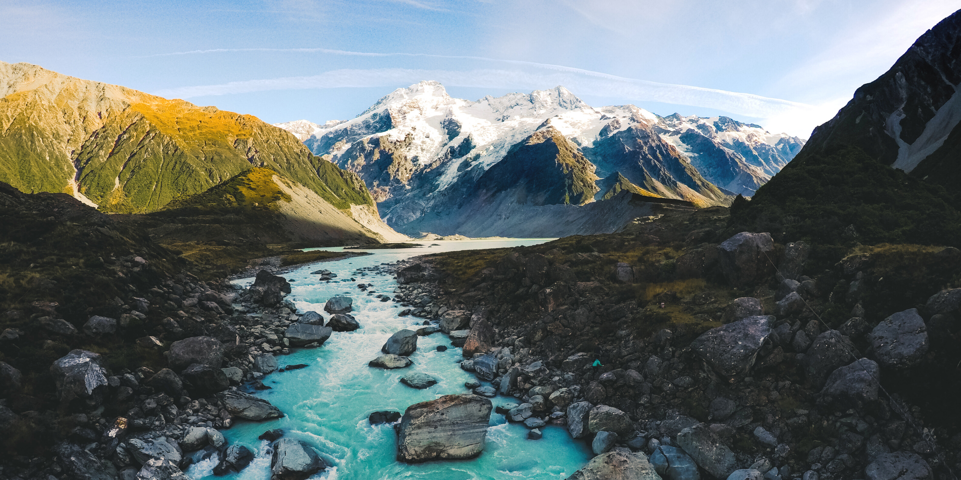 Scenic Kiwi road trip: Campervan overlooking Lake Tekapo's turquoise waters, South Island.