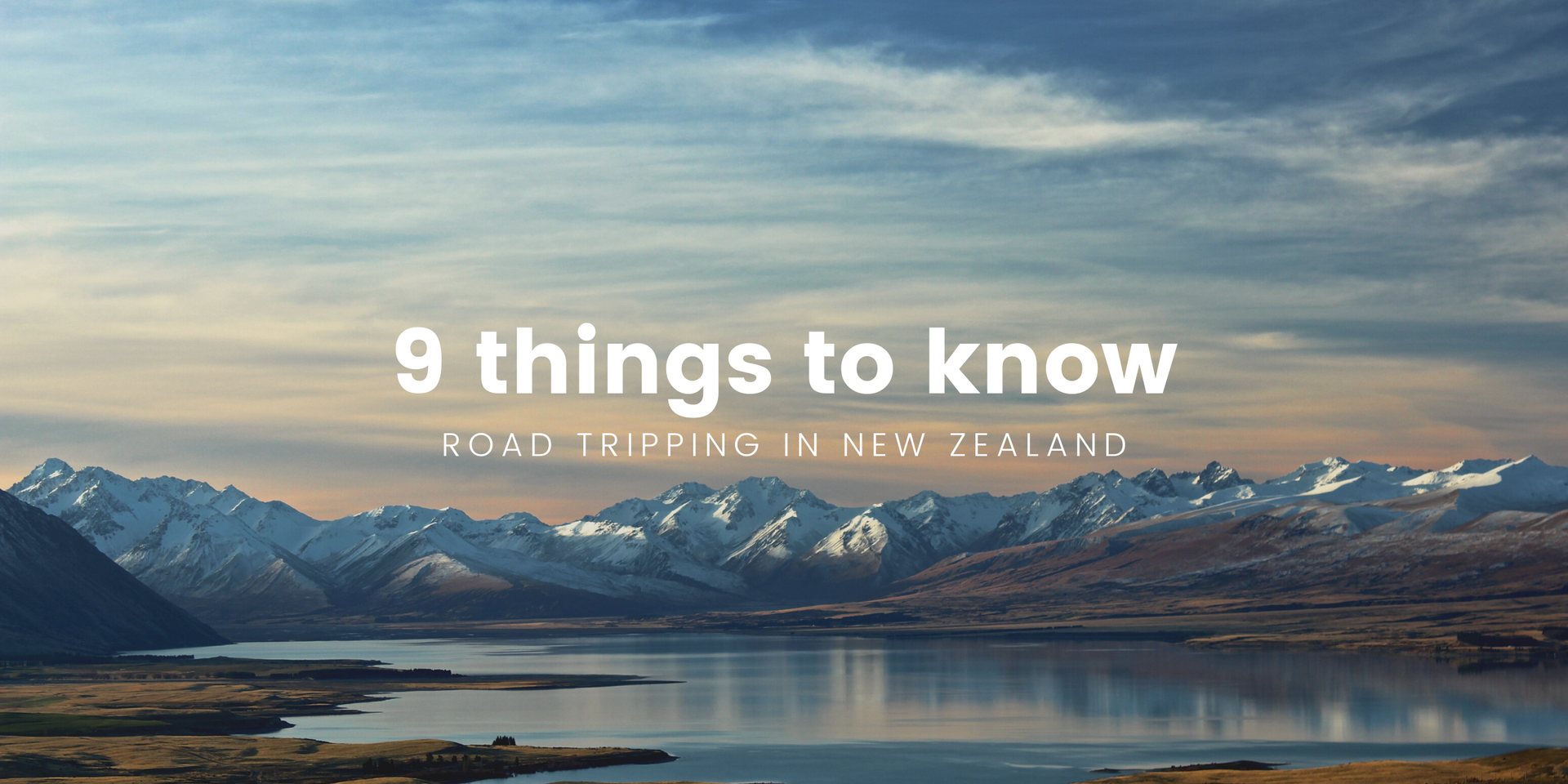 Campervan overlooking a stunning lake in the New Zealand countryside. Road trip vibes!