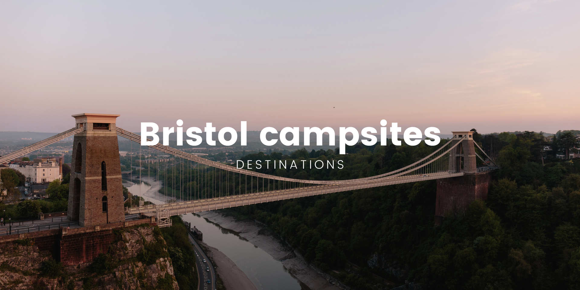 Tents pitched at a family campsite near Bristol, with rolling hills and cloudy sky in background.