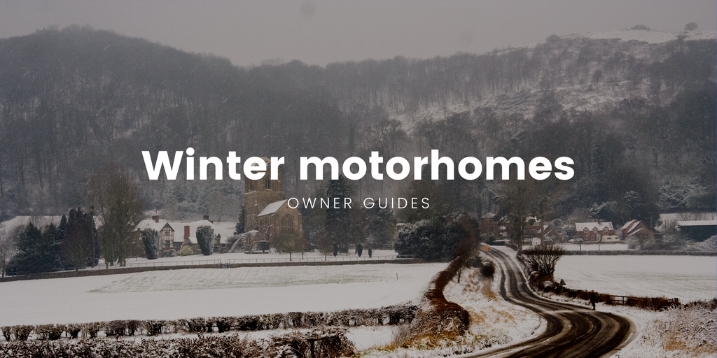 Motorhome parked in snowy British countryside, winter camping holiday.