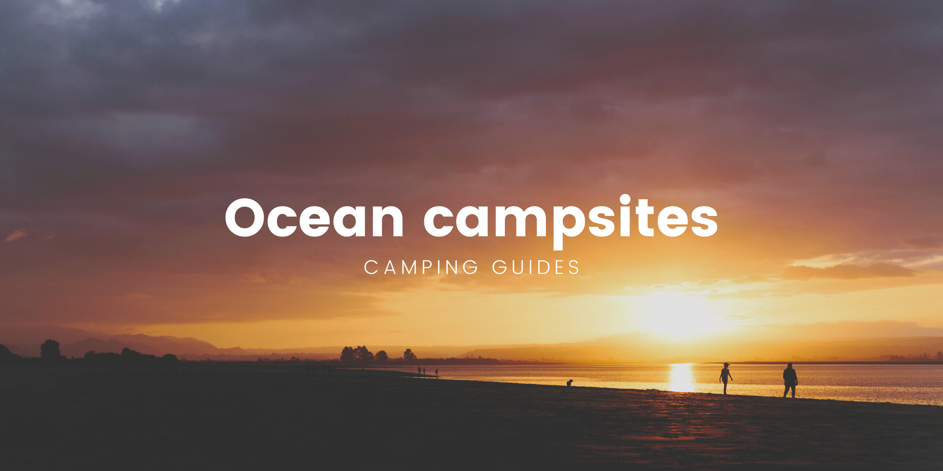 Tent pitched on a sandy beach, with the ocean and a rugged coastline in the background.