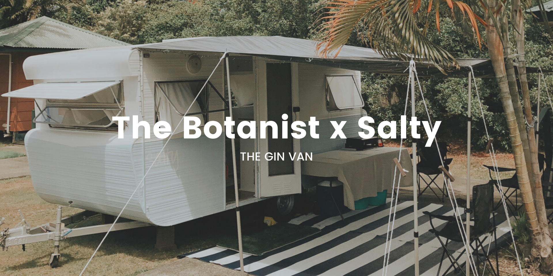Botanist Gin van set up at a coastal campsite, ready for a gin-tasting adventure.