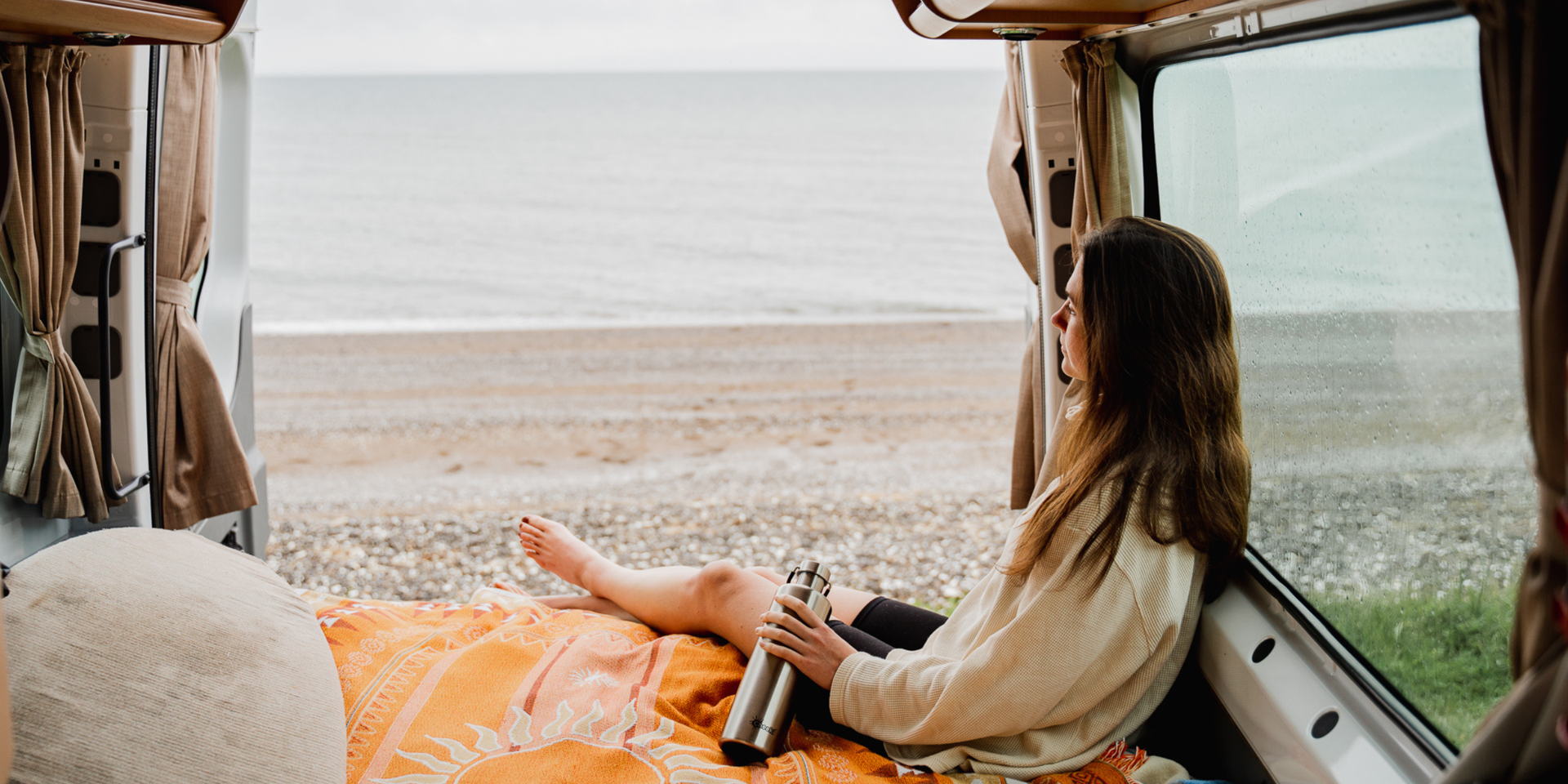 Campervan parked up in the NZ South Island, mountains in the background.