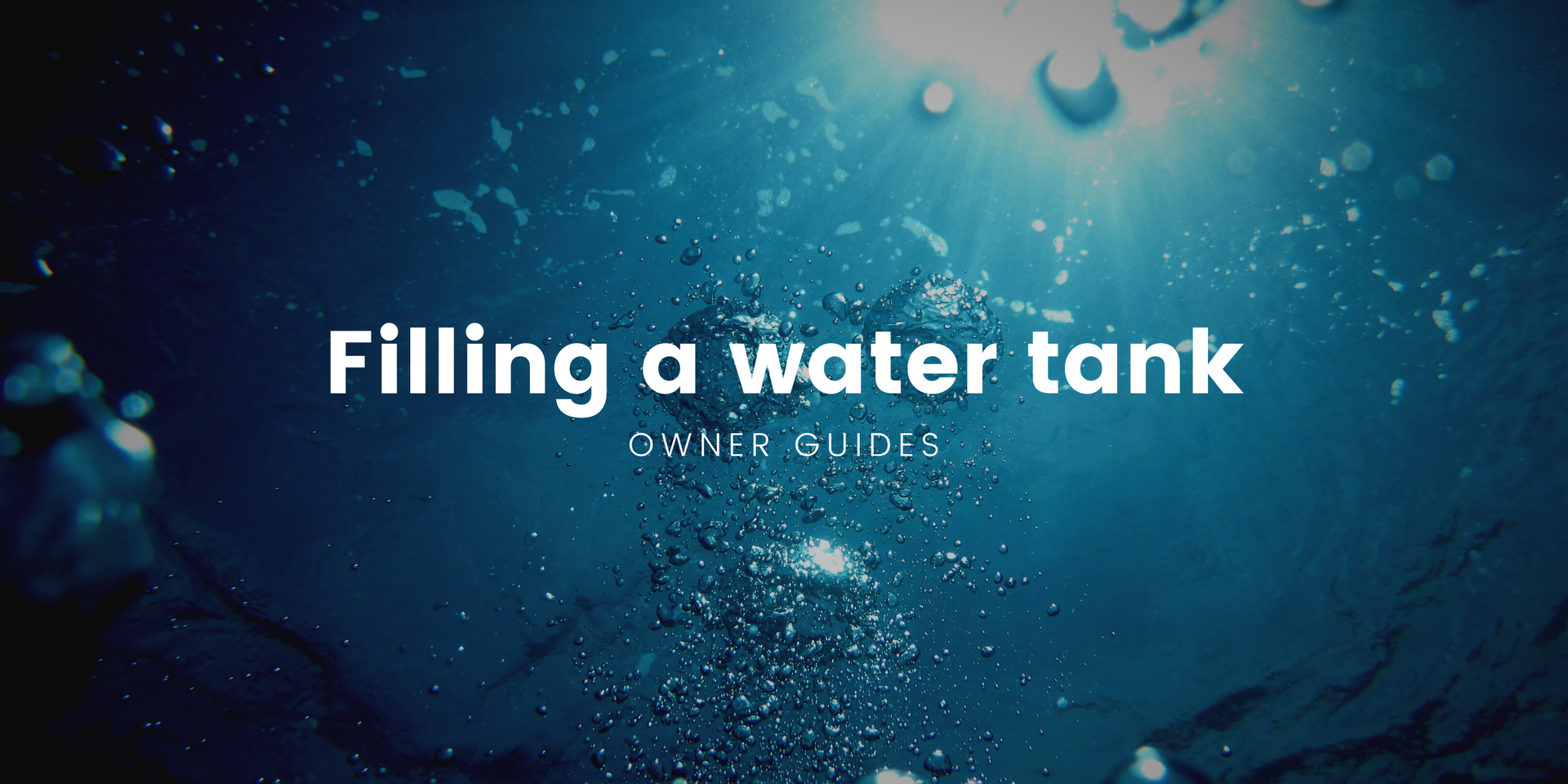 Motorhome at campsite water point, hose connected. Filling the water tank for a road trip.