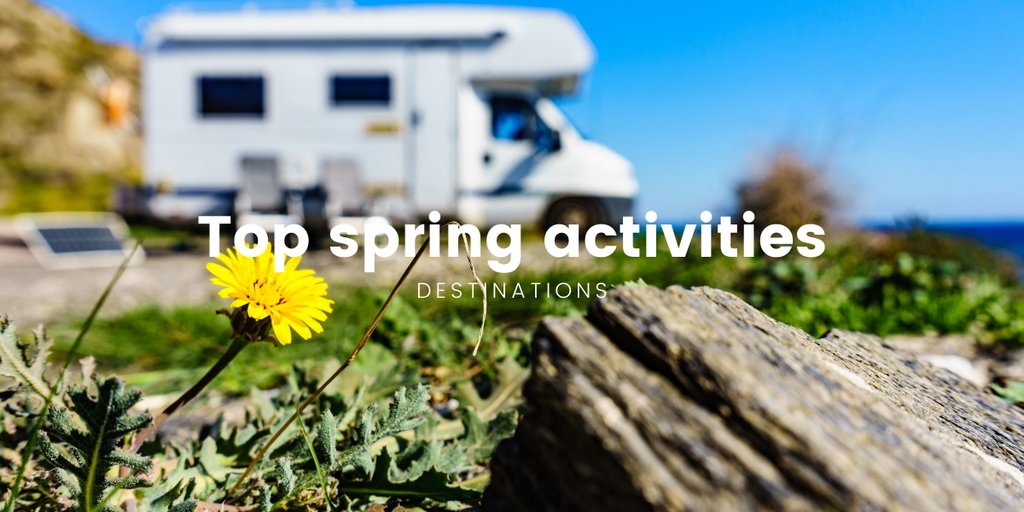 Campervan parked in a verdant field, ready for a UK spring road trip adventure.