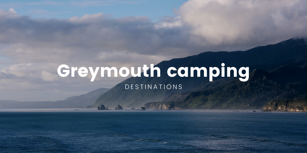 Tents and campervans at a sunny campground near Greymouth.
