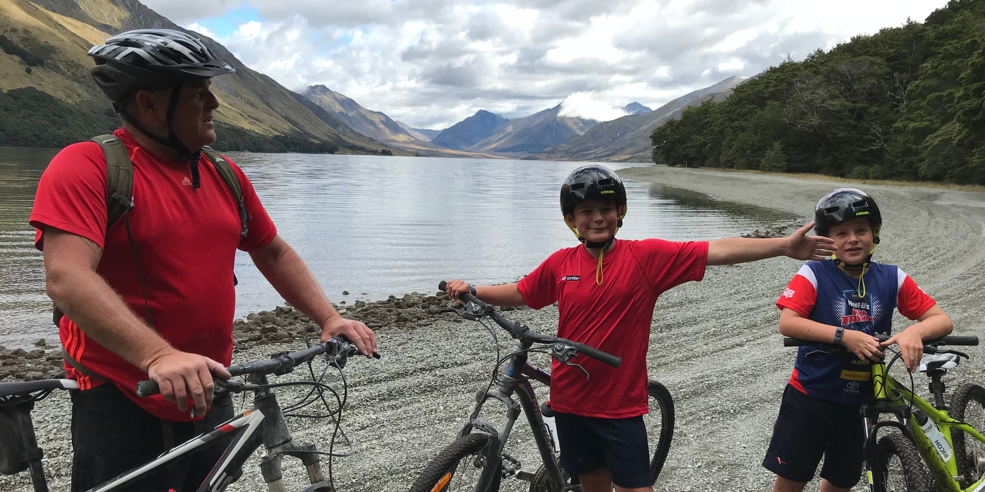 Couple toasting marshmallows around a campfire, campervan parked nearby. Good times, aye!