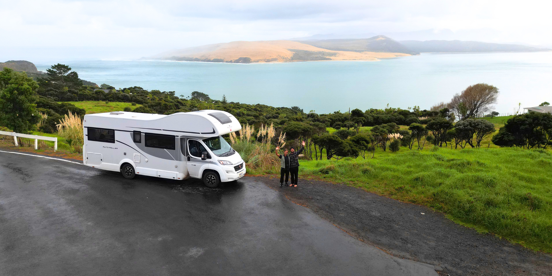 Campervan parked up at a stunning NZ beach. Surfboards out, ready for a mean session!