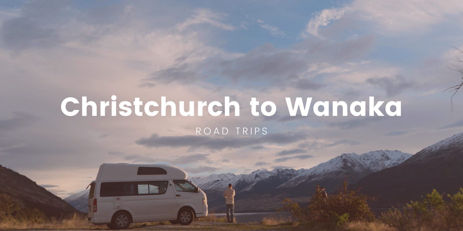 Scenic roadie from Christchurch to Wanaka. Campervan by a turquoise glacial lake in the South Island.