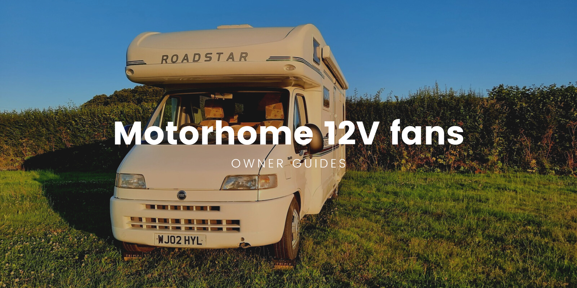 Motorhome parked up in a sunny campsite, perfect for a UK staycation with a 12v fan.