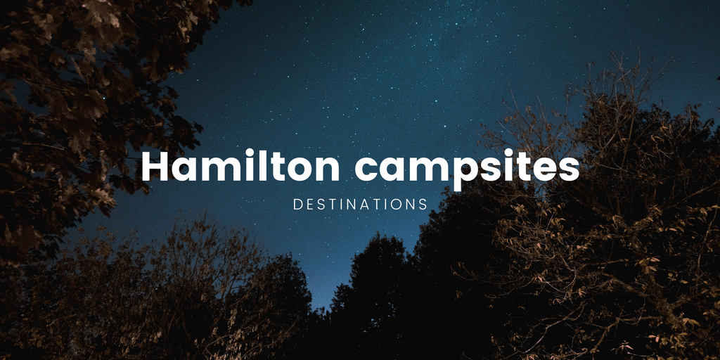 Family tent at a Hamilton camping ground, surrounded by native bush.