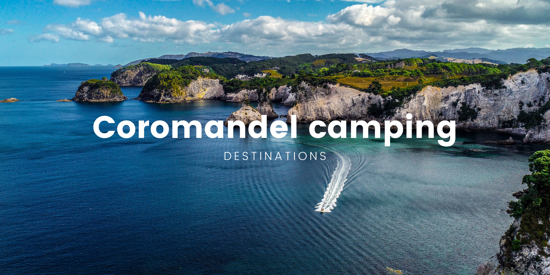 Tent under the stars at a Coromandel campsite, with native bush in the background.
