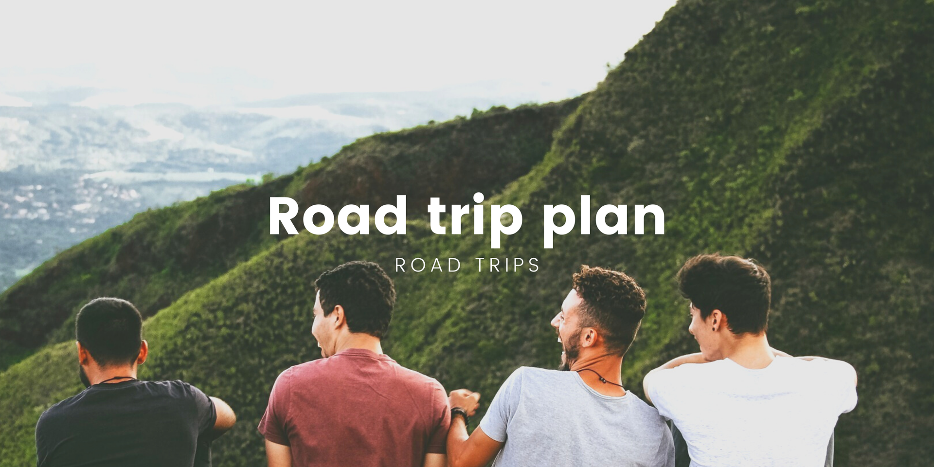 Friends on a road trip, laughing and pointing from a campervan parked on a scenic coastal road.