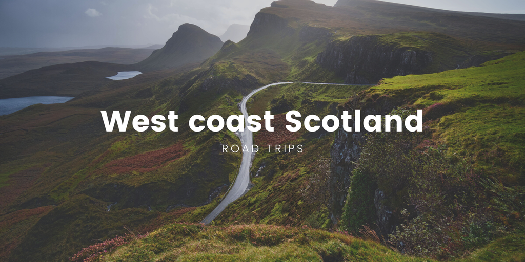 Scenic coastal road in Scotland; campervan parked overlooking the sea.