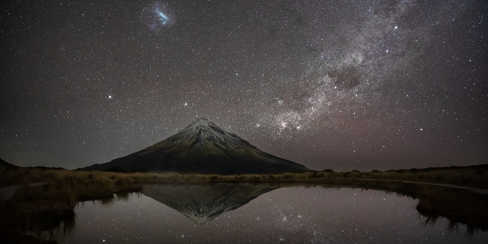 Stargazing from a campervan under the Milky Way in the New Zealand backcountry.