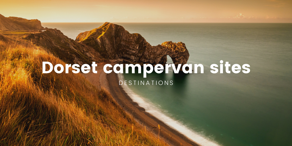 Campervan parked overlooking Durdle Door, Dorset. Coastal camping on a summer holiday.