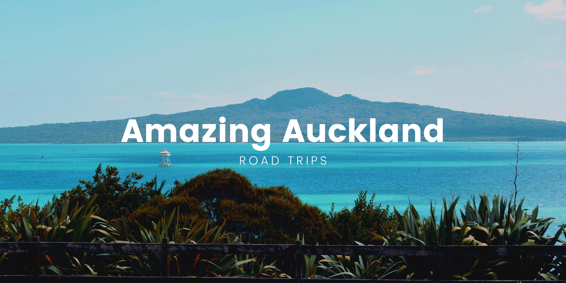 Road trip vibes: Campervan parked up with epic Auckland scenery in the background.