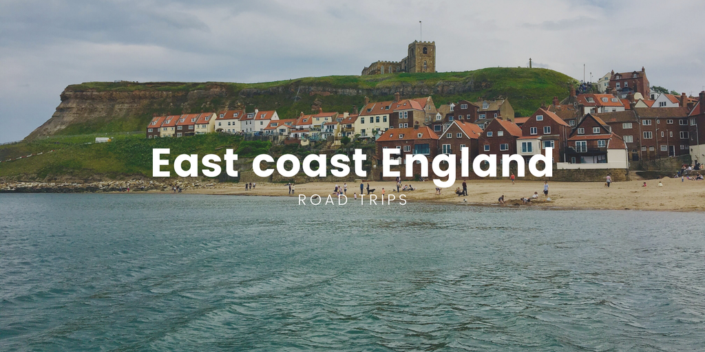 Campervan parked on clifftop overlooking the North Sea, East Coast England road trip.