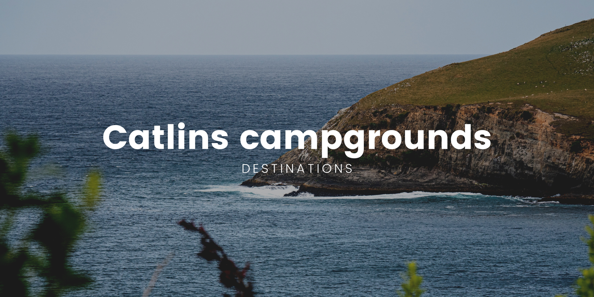 Camping scene at the Catlins coast with a campervan, beach, and moody sky.