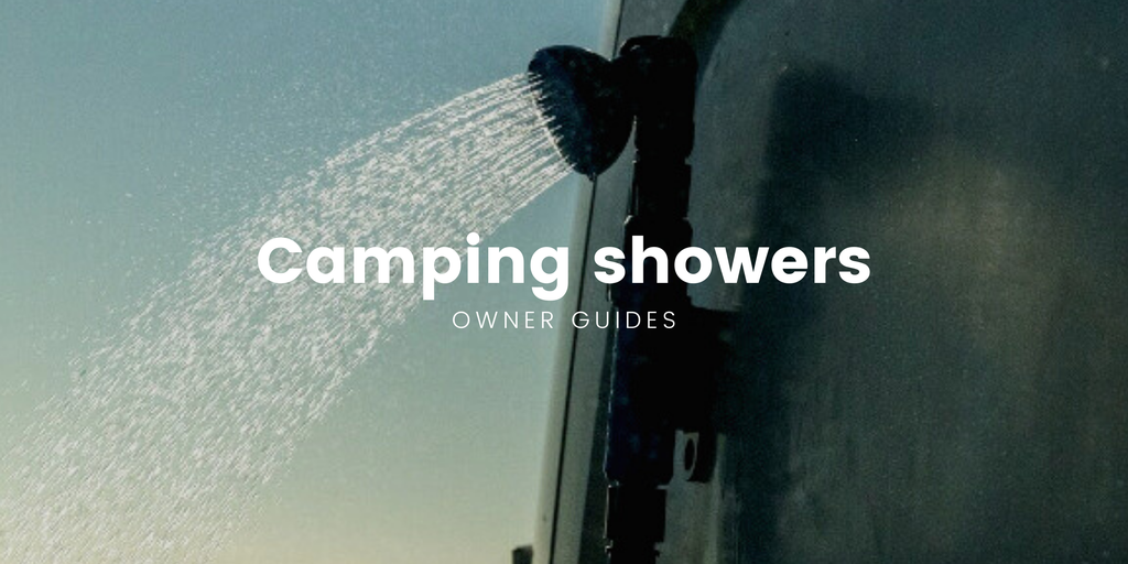 Campervan parked by a river in the bush, freedom camping in Aotearoa.