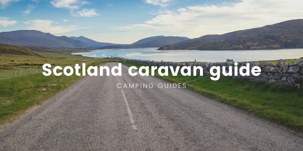 Caravan on scenic Scottish road trip, with mountains in the background.