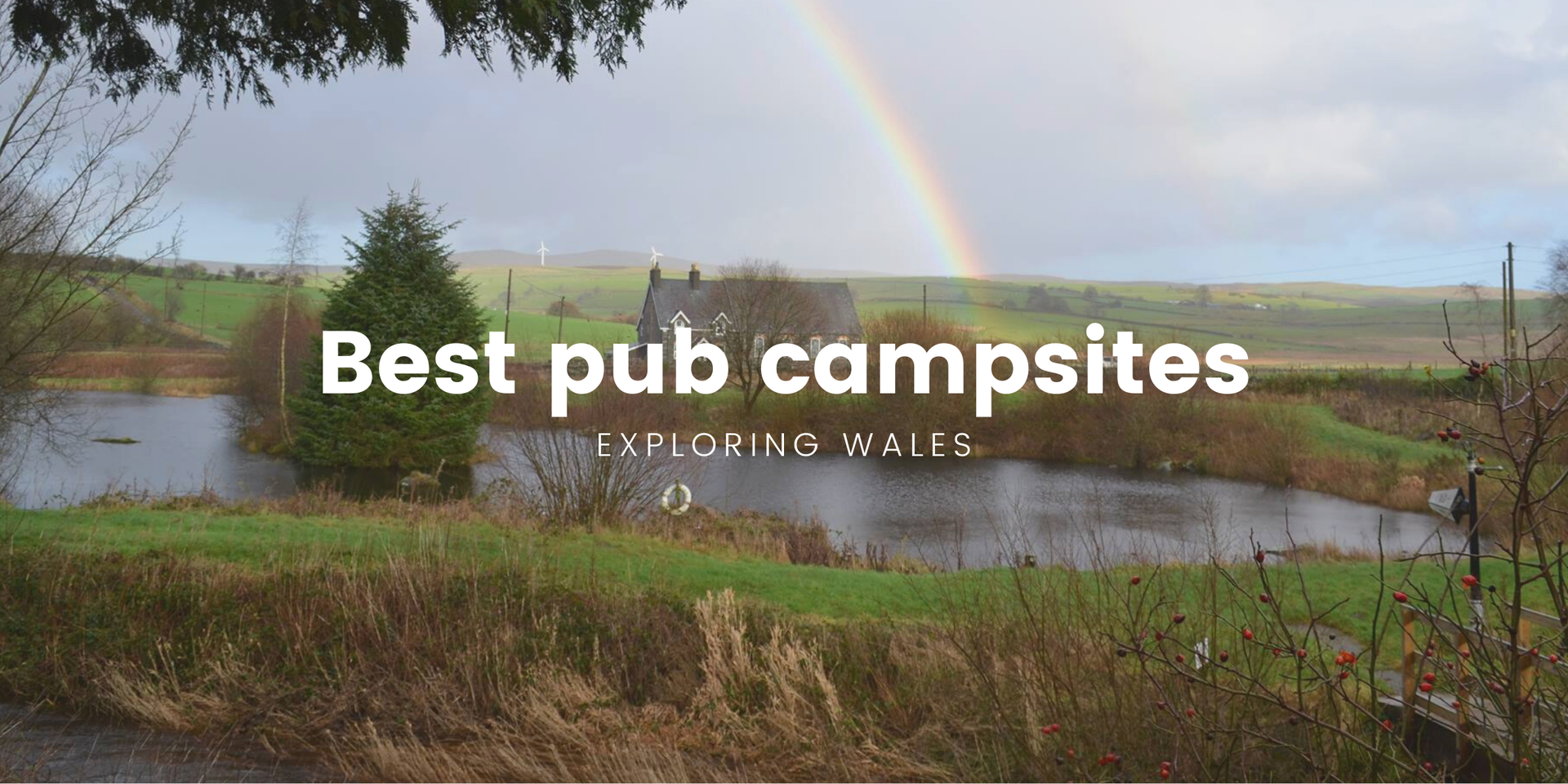 Tent pitched outside a traditional Welsh pub, enjoying a countryside camping holiday.