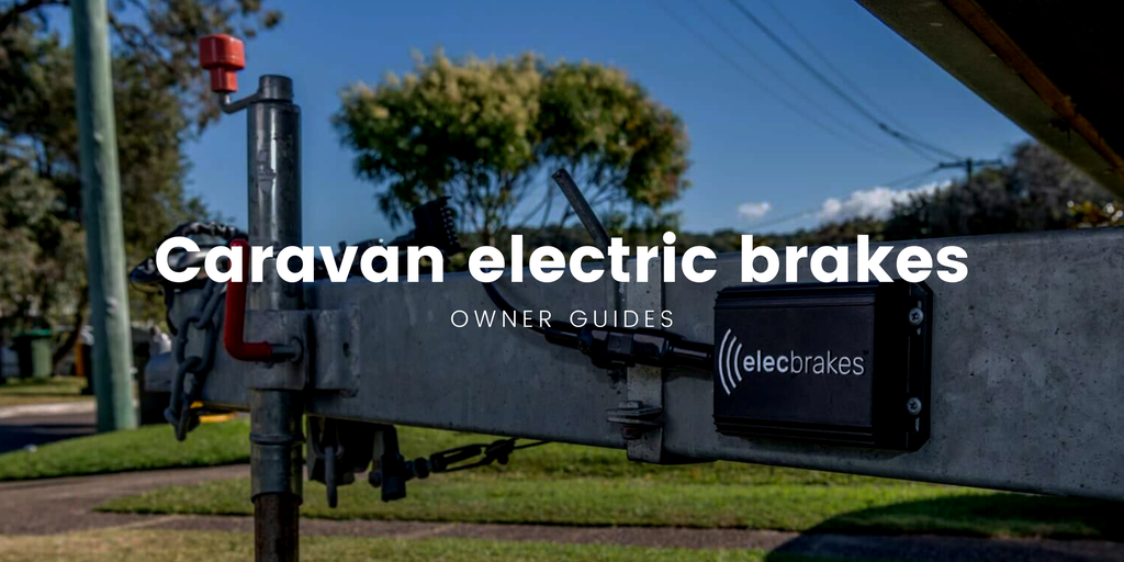Caravan brakes being inspected at a dusty outback roadside stop.
