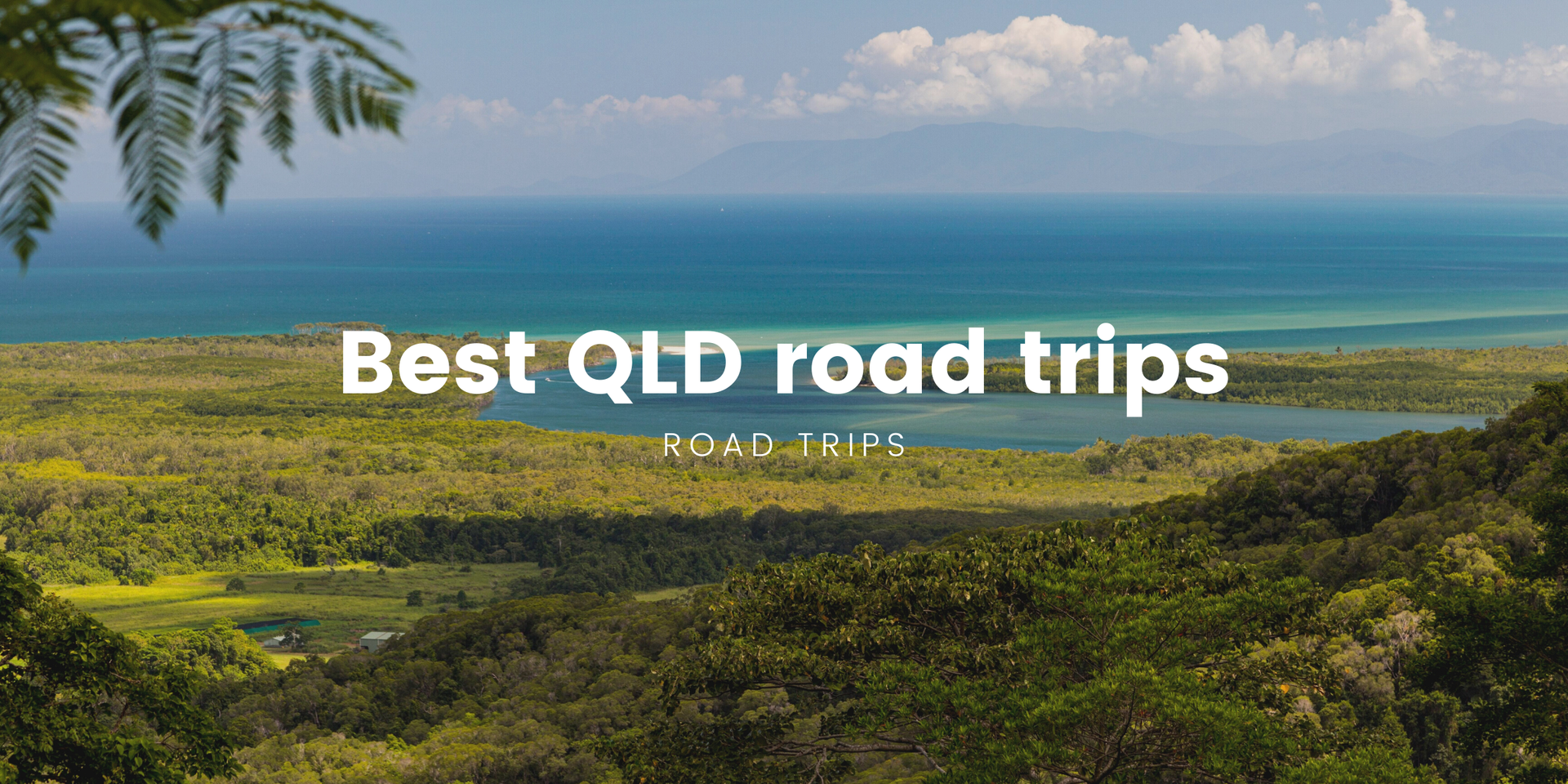 Van parked overlooking a sunny Queensland beach, ready for a road trip adventure.