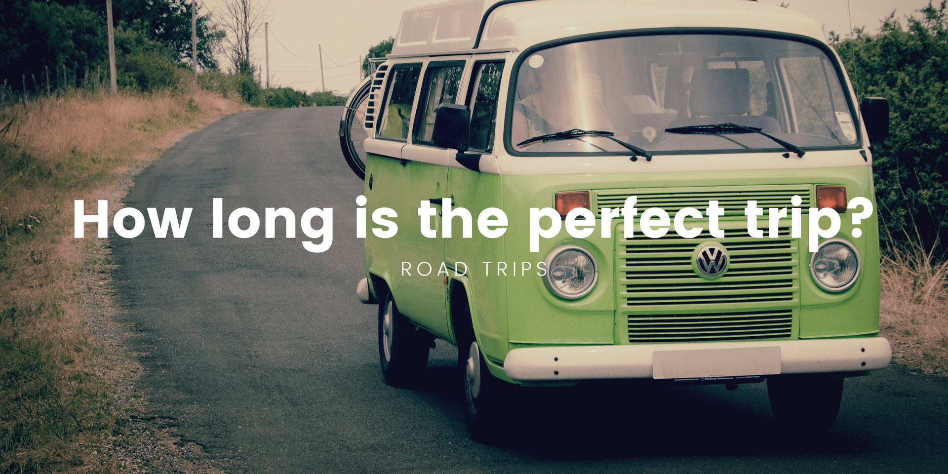 Campervan parked by a scenic loch in the Scottish Highlands. Road trip adventure.