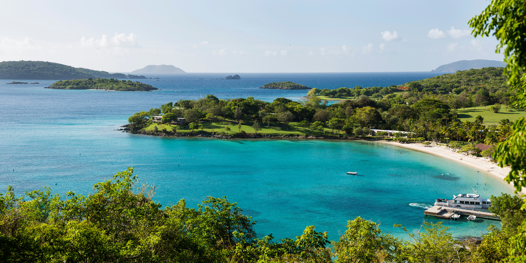 Snow-capped mountains reflected in a pristine lake, a campervan parked nearby for a winter roadie.