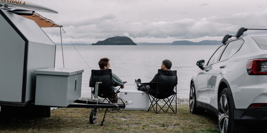 Campervan parked up next to a turquoise lake in the South Island, Aotearoa.