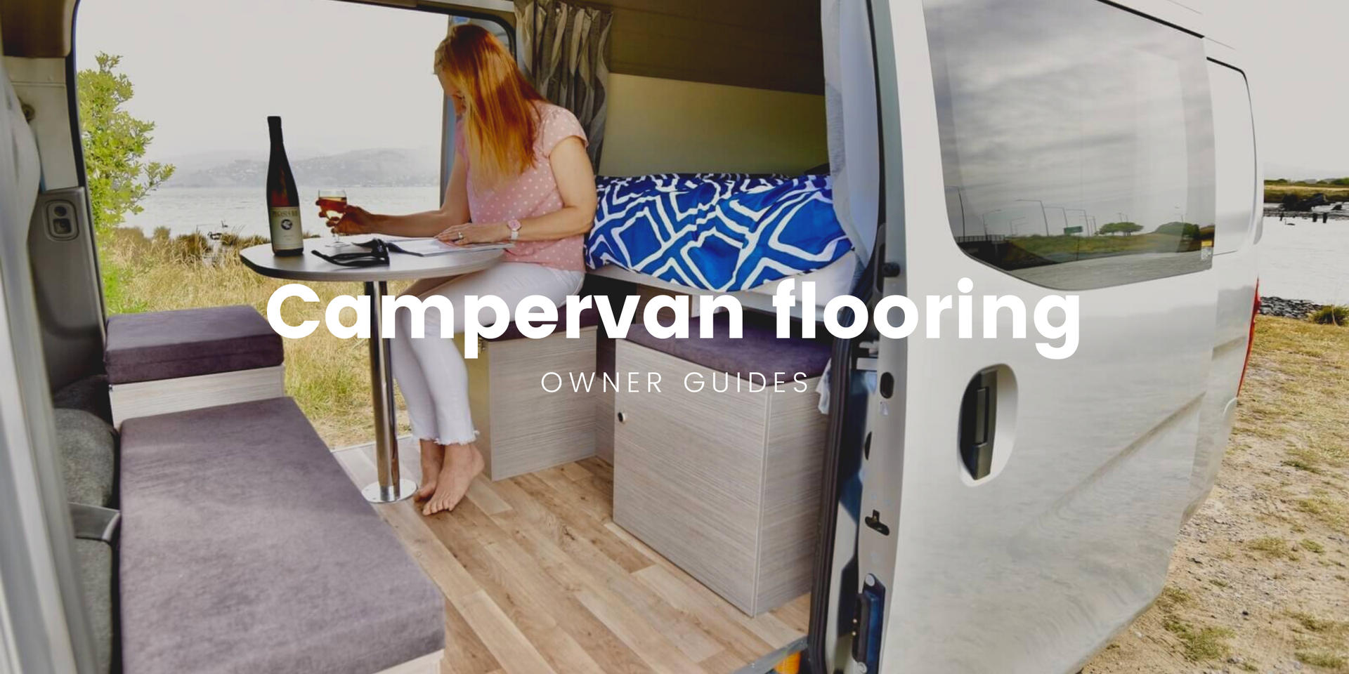 Cosy campervan interior with timber-look flooring, ready for a road trip.