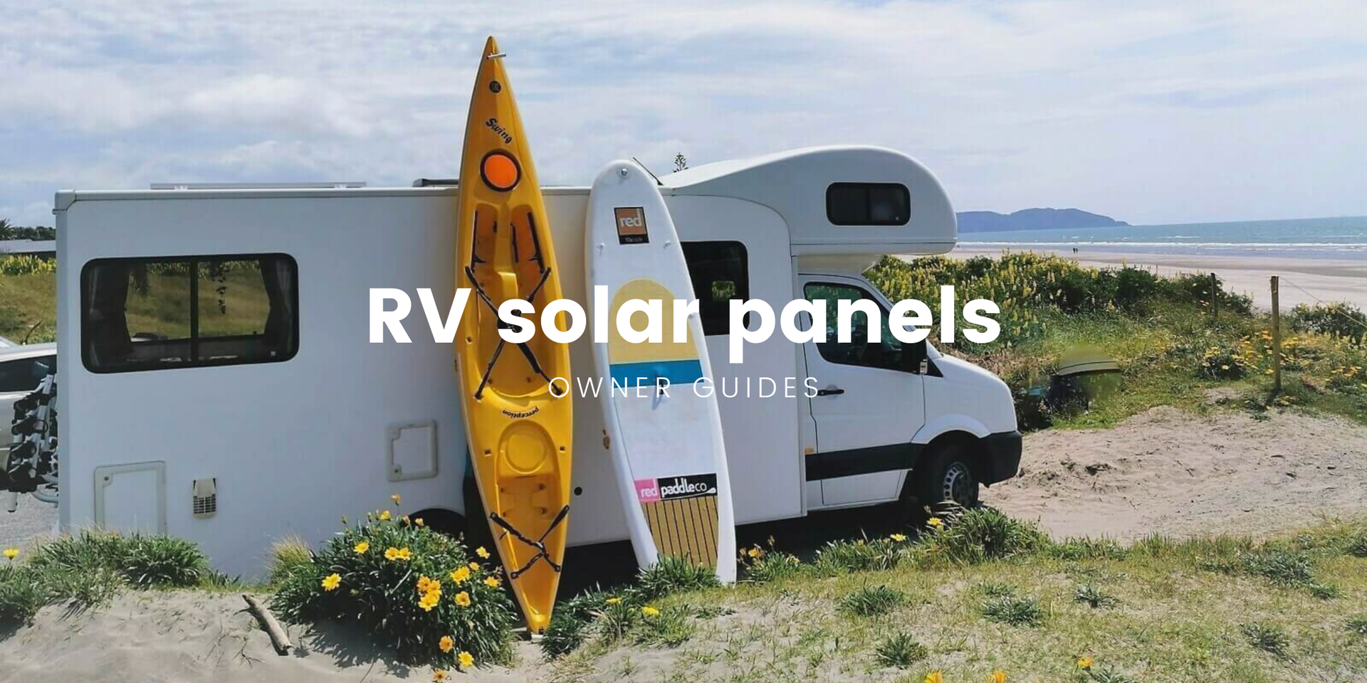 Motorhome parked up by a scenic lake, ready for a Kiwi camping adventure.