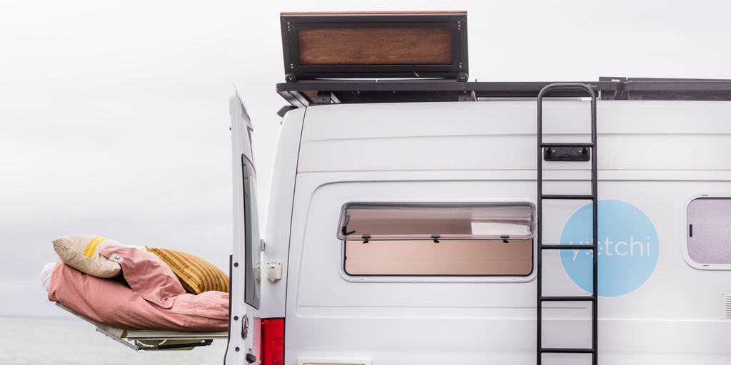 Luxe Yotchi campervan parked at a coastal campsite. Glamping in style down under!