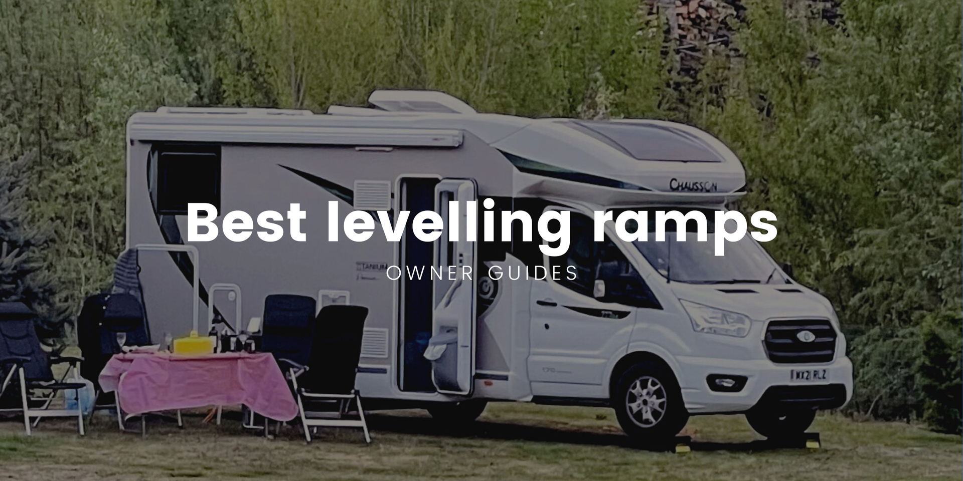 Motorhome using levelling ramps at a sunny campsite. Campervan holiday adventure.