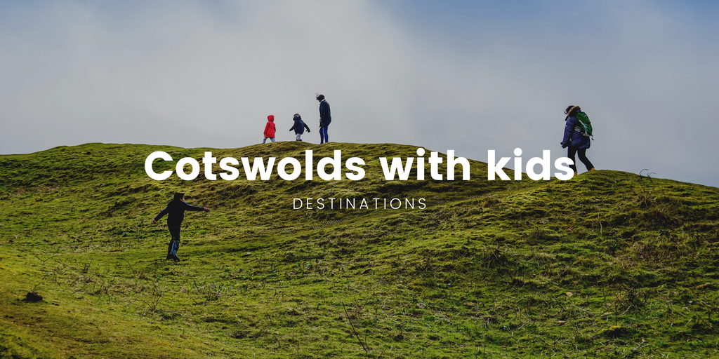 Family pitching tent at Cotswolds campsite. Rolling hills and blue skies create an idyllic camping scene.