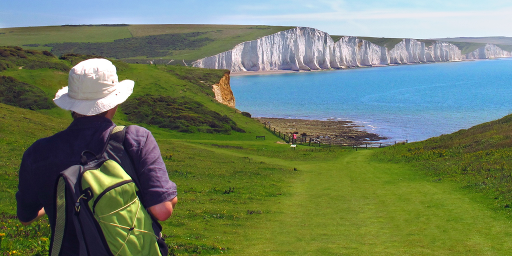 Hikers on a scenic trail in Surrey, enjoying a day out from London amidst lush green hills.
